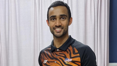 Harinder Sekhon in a black and orange sports shirt